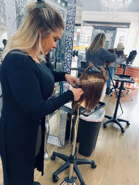 Michelle working on her hair piece at training seminar