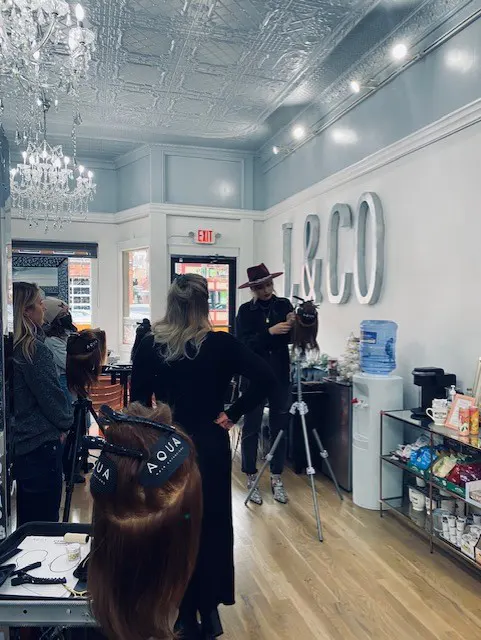 Instructor demonstrating techniques in upscale hair salon