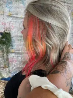 Blonde hair with red yellow and orange dyed streaks